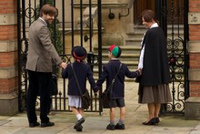 Family Of Four Entering Old School Gates