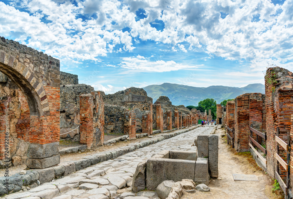 Ancient street in Pompeii, Italy. Roman ruins of famous city near Naples. - obrazy, fototapety, plakaty 