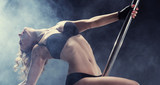 Sport. Pole dancer, woman dancing on pylon