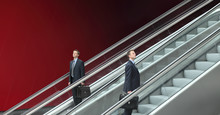 Business Man Going Up And Down Escalators, Concept Of Success