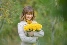 Happy Girl With A Bouquet Of Yellow Roses