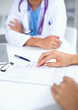 © lenets_tan - Doctor and patient sitting on the desk  at office