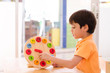 Little boy learning time with clock toy of montessori 