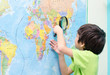 © wckiw - Little boy using magnify looking on map