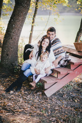 Wall Mural - Happy family in an autumn forest