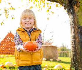 Wall Mural - Portrait of happy child with pumpkin