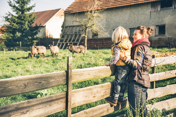 Wall Mural - Portrait of mother and child on farm