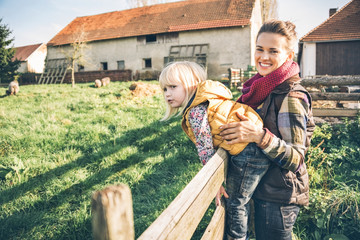 Wall Mural - Portrait of happy mother and child on farm