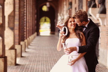 Happy bride and groom holding LOVE letters