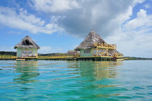 Tropical Bungalows Over Water With Thatch Roof