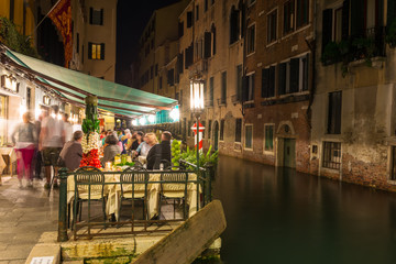 Wall Mural - Night view of canal and restaurant in Venice, Italy