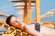 © nenadaksic - Young woman chilling on the beach