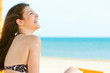 © nenadaksic - Young woman chilling on the beach