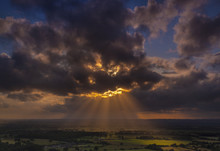 Crepuscular Rays Of Sunlight Shine Onto Fields In Dorset