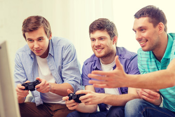 Poster - smiling friends playing video games at home