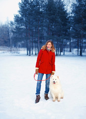 Wall Mural - Winter park, pretty woman with Samoyed dog outdoors