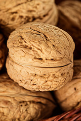 Wall Mural - Whole walnuts in a wicker basket close-up