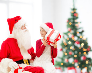 Poster - smiling little girl with santa claus and gifts