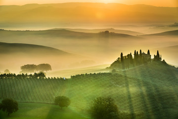 Wall Mural - sunrise over the green fields in tuscany