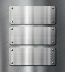 Wall Mural - three stainless steel metal plates on brushed background