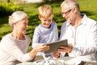 © Syda Productions - happy family with tablet pc outdoors