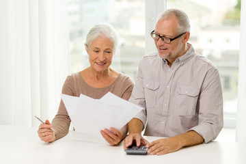 Poster - senior couple with papers and calculator at home