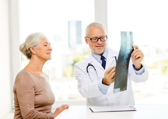 Canvas Print - smiling senior woman and doctor meeting