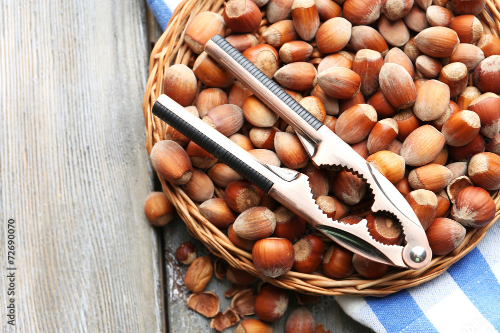 Hazelnuts on wicker mat on wooden background