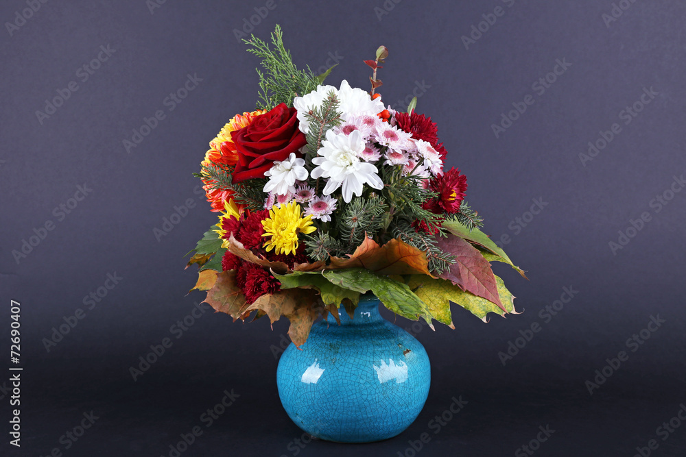 Flower bouquet in blue vase on dark grey background
