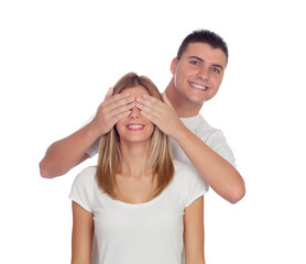 Wall Mural - Smiling boy covering his girlfriend's eyes to surprise him