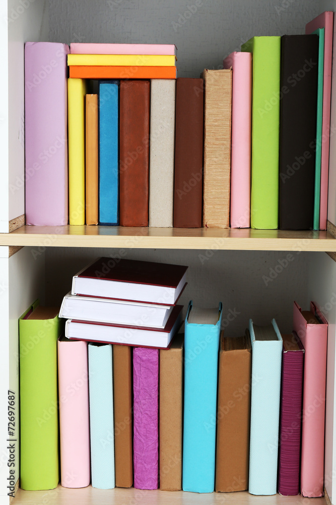 Books on wooden shelves close-up