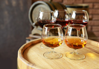 Poster - Glasses of brandy in cellar with old barrels