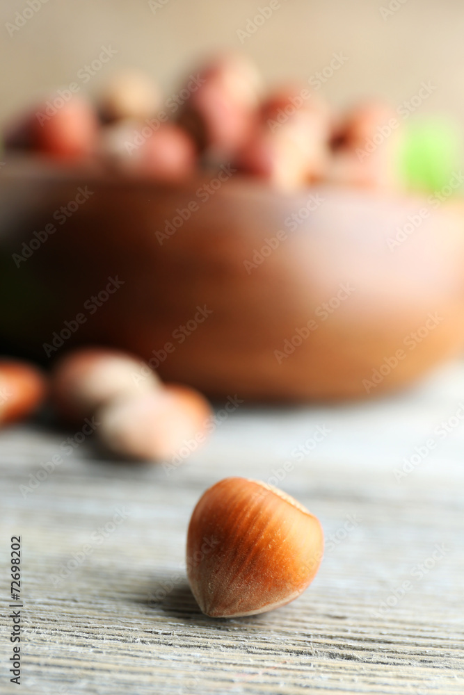 Hazelnut on  wooden bowl background