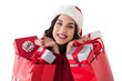 © WavebreakmediaMicro - Excited brunette holding shopping bags full of gifts