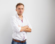 © Kaspars Grinvalds - Young creative man standing with arms crossed