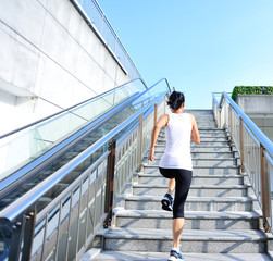 Wall Mural - Runner athlete running on escalator stairs. 