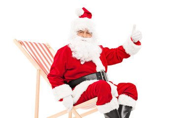 Poster - Santa giving a thumb up seated in a sun lounger