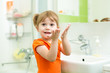© Oksana Kuzmina - Cute little girl washing hands in bathroom