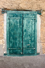 Green Flaking Painted Wooden Closed Shutters