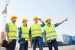 © Syda Productions - group of smiling builders with tablet pc outdoors