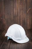 Fototapeta Nowy Jork - Construction hard hat on wooden background