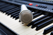 The Microphone Lies On The Synthesizer Keyboard