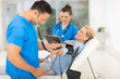 © michaeljung - medical doctor taking mid age woman's blood pressure