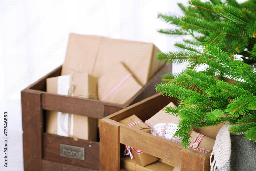 Christmas presents and decorations in boxes near Christmas tree