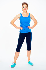 Wall Mural - fitness woman in sport style standing against white background