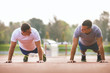 © bokan - Two young athletes doing push-ups