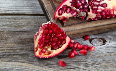 juicy ripe pomegranates on vintage wood