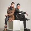 © Viorel Sima - Side view of young fashion couple sitting