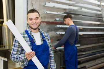 Two workers choosing PVC window profile