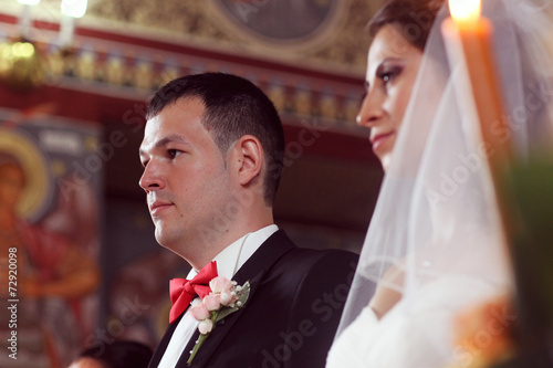 Fotografie, Obraz bride and groom in church front of priest